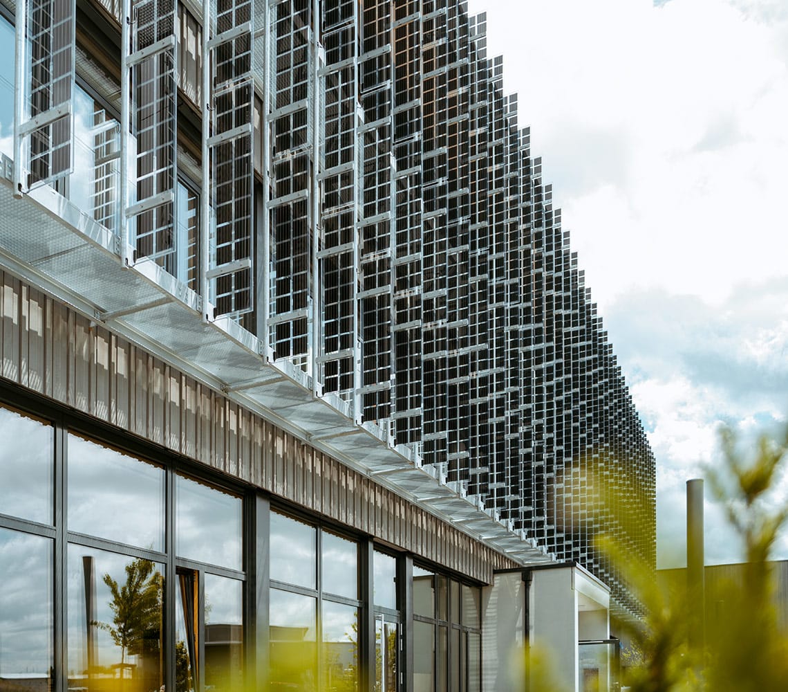 A contemporary structure equipped with solar panels on its exterior, highlighting eco-friendly design.